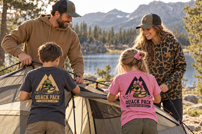 AI-generated lifestyle mockup: Family camping wearing Sawtooth hoodies and youth Quack Pack tees